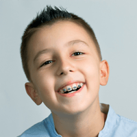 Smiling young boy with braces