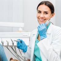 Dentist smiling at patient's dental exam.
