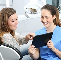 Implant dentist speaking with a patient