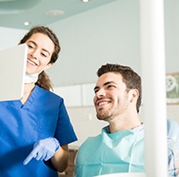 Implant dentist showing a patient’s costs