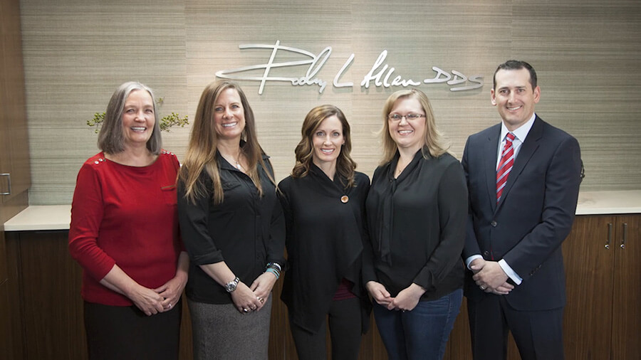 Smiling dentist and team members
