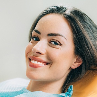 Woman with attractive smile after fixing gap in teeth.