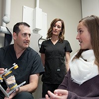 Dr. Rodney and assistant soothing patient