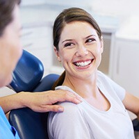 Woman looking up smiling during dental checkup