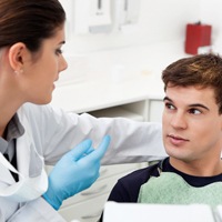 A dentist talking to a male patient about Invisalign