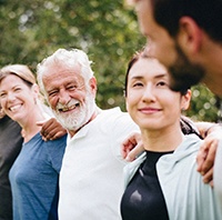 Diverse group of people outside doing team building exercises