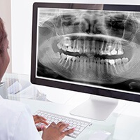 Dentist examining x-ray