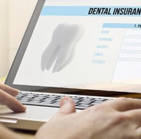 Filling out a dental insurance form on a laptop