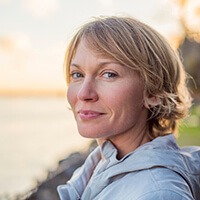 woman smiling enjoying the sunset after tooth extraction