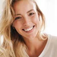 Closeup of woman with blonde hair smiling.