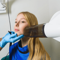 Girl receiving digital dental x-rays