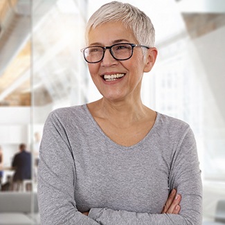 Woman with an implant denture in Parker smiling at work