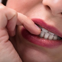 closeup of woman biting fingernails