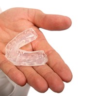 person holding mouthguard