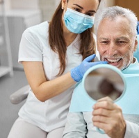 man smiling during dental checkup in Parker