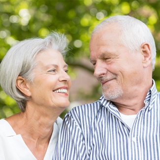 An older couple smiling at each other