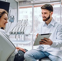 dentist telling a patient about dental implant post-op instructions in Parker 