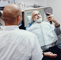 man beaming at his new dental implants