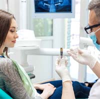 patient speaking to dentist about dental implants in Parker