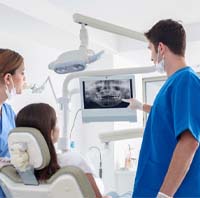 implant dentist in Parker showing a patient X-rays of their mouth
