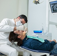Implant dentist in Parker examining a patient.