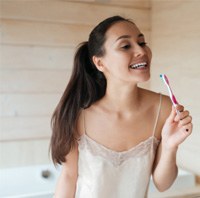 Woman brushing her teeth