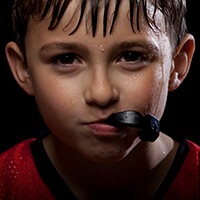 boy biting mouthguard