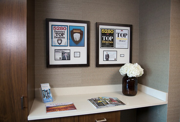 Shelf with awards and magazines in Parker colorado dental office