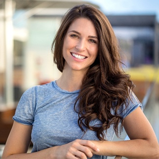 Woman smiling outside after oral cancer screening