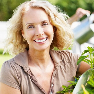 Woman smiling after receiving restorative dentistry in Parker Colorado