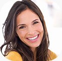 Brunette Woman laughing with flawless smile after cosmetic dentistry