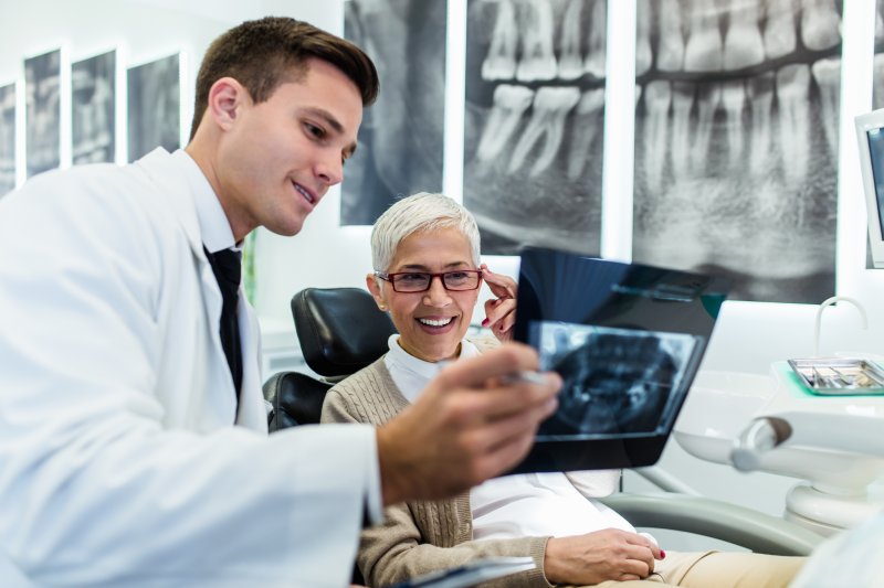 An emergency dentist showing a patient an X-ray.