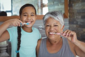 a parent and their child brushing their teeth in a bathroom