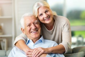 Mature couple cuddling and smiling