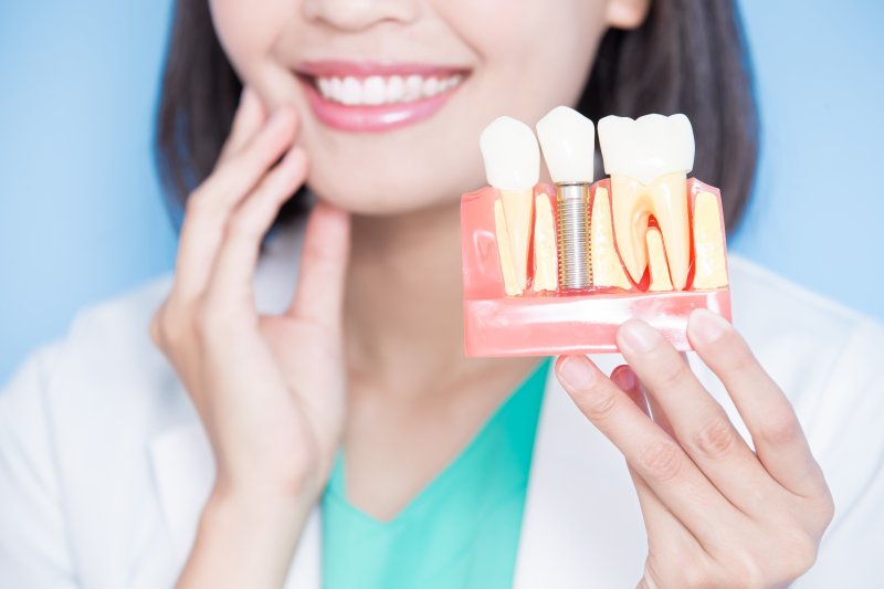 a person showing dental implants in Parker