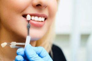 a woman getting veneers safely placed at her dentist 