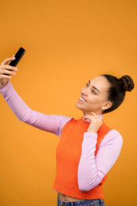 Woman taking a selfie with cellphone